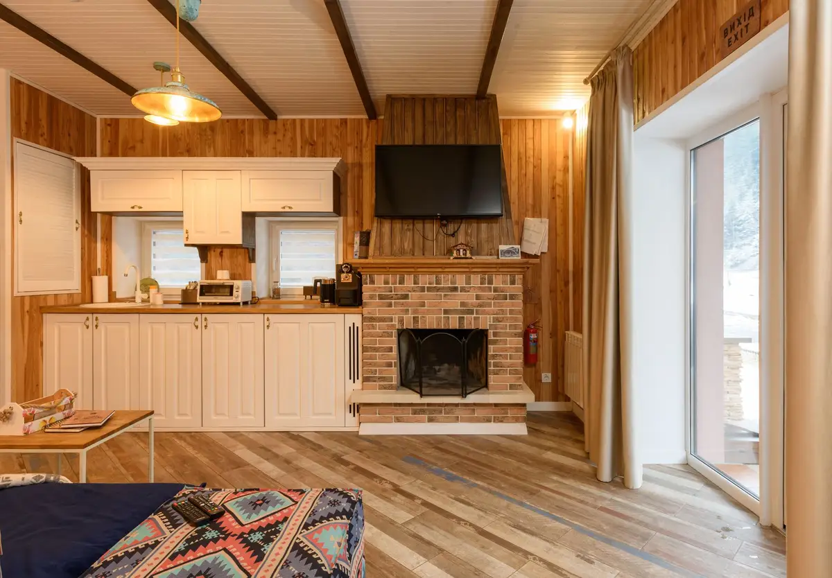 Apartmán s kuchyňkou, cihlovým krbem a dřevěnou podlahou